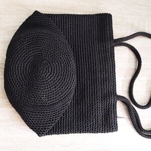 Black Woven Straw Bucket Bag with Round Flap Brand The Sak.